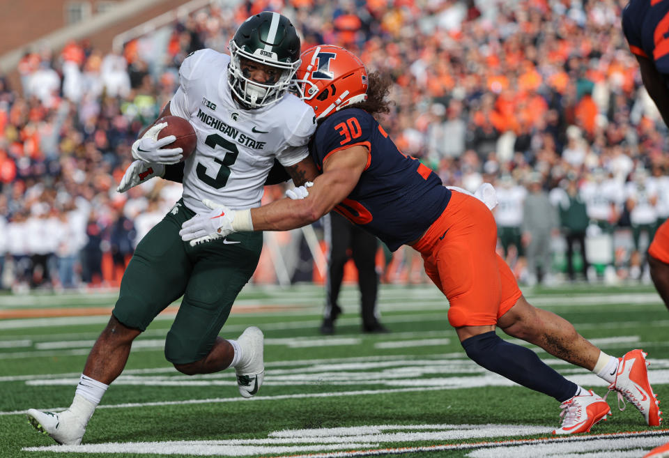 Michigan State's Jarek Broussard runs the ball as Illinois defender Sydney Brown tackles him during the game on November 5, 2022 in Champaign, Illinois. (Photo by Michael Hickey/Getty Images)