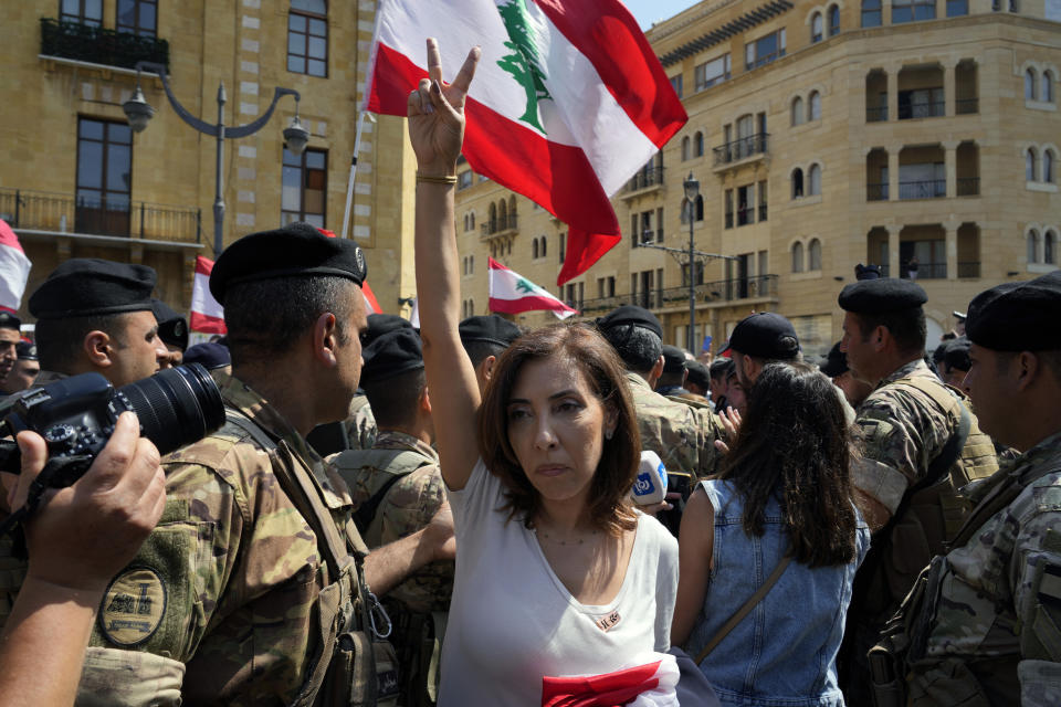 Thirteen independent candidates drawn from the 2019 protest movement walk toward parliament building from Beirut’s port the scene of a massive explosion in August 2020, Tuesday, May 31, 2022. Lebanon's new parliament is holding its first meeting during which longtime speaker Nabih Berri is expected to be elected for a seventh four-year term, despite more than a dozen new lawmakers who won seats running on a reform platform. (AP Photo/Bilal Hussein)