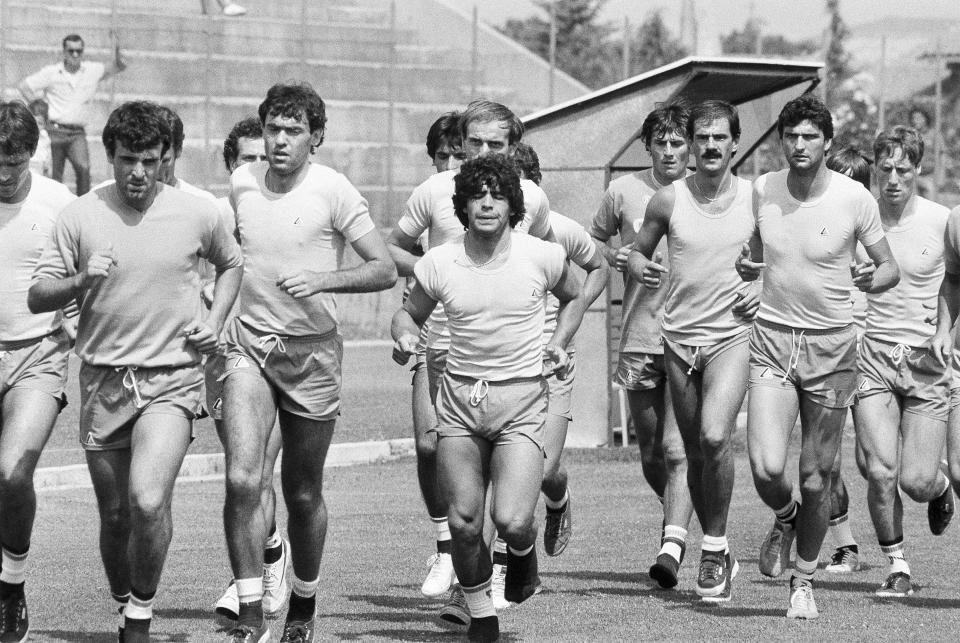 FILE - Argentine soccer star Diego Armando Maradona, center, trains with Napoli teammates at Castel del Piano, Italy on July 27, 1984. The legend of Diego Maradona at Napoli hovers over the current team’s Italian league title, which was sealed Thursday, May 4, 2023. The Argentina standout holds saint-like status in Naples 2 ½ years after his death and more than three decades after he led Napoli to its first two Serie A titles. (AP Photo/Massimo Sambucetti, File)