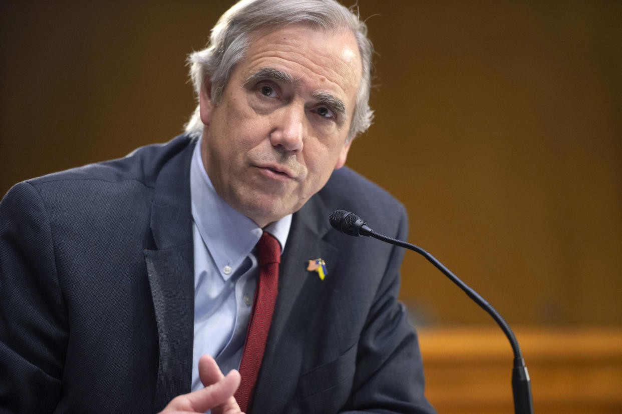 Sen. Jeff Merkley at the microphone.