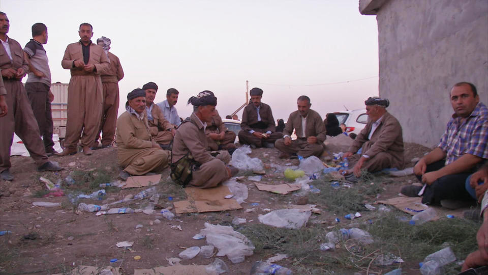 This image made from video taken on Sunday, Aug. 3, 2014 shows Iraqis people from the Yazidi community after arriving in Irbil in northern Iraq after Islamic militants attacked the towns of Sinjar and Zunmar. Around 40 thousand people crossed the bridge of Shela in Fishkhabur into the Northern Kurdish Region of Iraq, after being given an ultimatum by Islamic militants to either convert to Islam, pay a security tax, leave their homes, or die. (AP Photo via AP video)