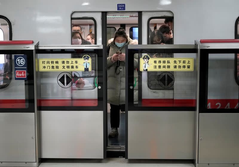 People wearing masks are seen on the subway in Beijing