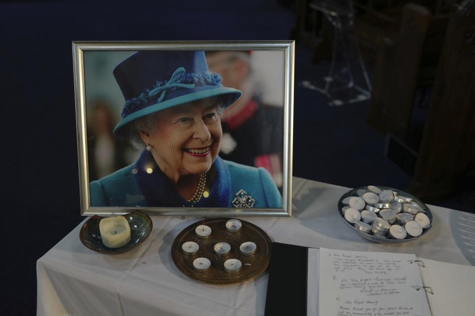 A book of condolence and photo of Queen Elizabeth II are displayed at a church in the district of Southall in London, Tuesday, Sept. 13, 2022. In a church in a West London district known locally as Little India, a book of condolence for Queen Elizabeth II lies open. Five days after the monarch’s passing, few have signed their names. The congregation of 300 is made up largely of the South Asian diaspora, like the majority of the estimated 70,000 people living in the district of Southall, a community tucked away in London's outer reaches of London and built on waves of migration that span 100 years. (AP Photo/Kin Cheung)