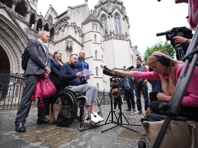 Martin Hibbert, centre, speaks to the media outside the Royal Courts of Justice