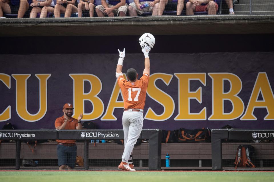 Texas' Ivan Melendez gestures to the crowd after his home run during the first inning of an NCAA college super regional baseball game against East Carolina on Sunday, June 12, 2022, in Greenville, N.C.