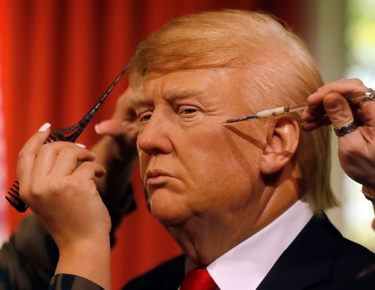 Madame Tussauds' designers apply the final touches to the wax figure of President-elect Donald Trump, as they unveil the figure just days ahead of the American's Presidential Inauguration in Washington in London, Wednesday, Jan. 18, 2017. The figure will now reside in Madame Tussauds' London Oval Office alongside fellow famous politicians and global icons also immortalised in wax. (Photo: Frank Augstein/AP)