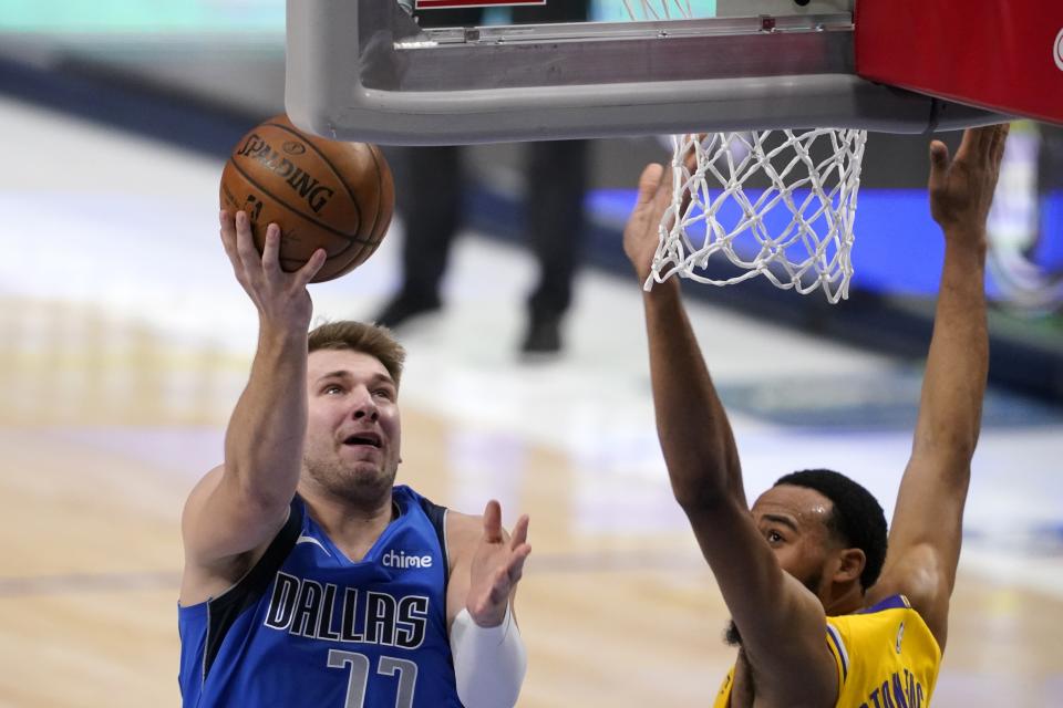 Dallas Mavericks' Luka Doncic (77) goes up to shoot as Los Angeles Lakers' Talen Horton-Tucker, right, defends in the first half of an NBA basketball game in Dallas, Thursday, April 22, 2021. (AP Photo/Tony Gutierrez)
