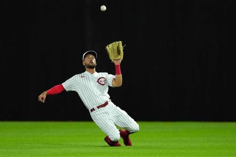 Cincinnati Reds center fielder Albert Almora Jr. (3) completes a catch during the ninth inning of a baseball game against the Chicago Cubs, Thursday, Aug. 11, 2022, at the MLB Field of Dreams stadium in Dyersville, Iowa. 