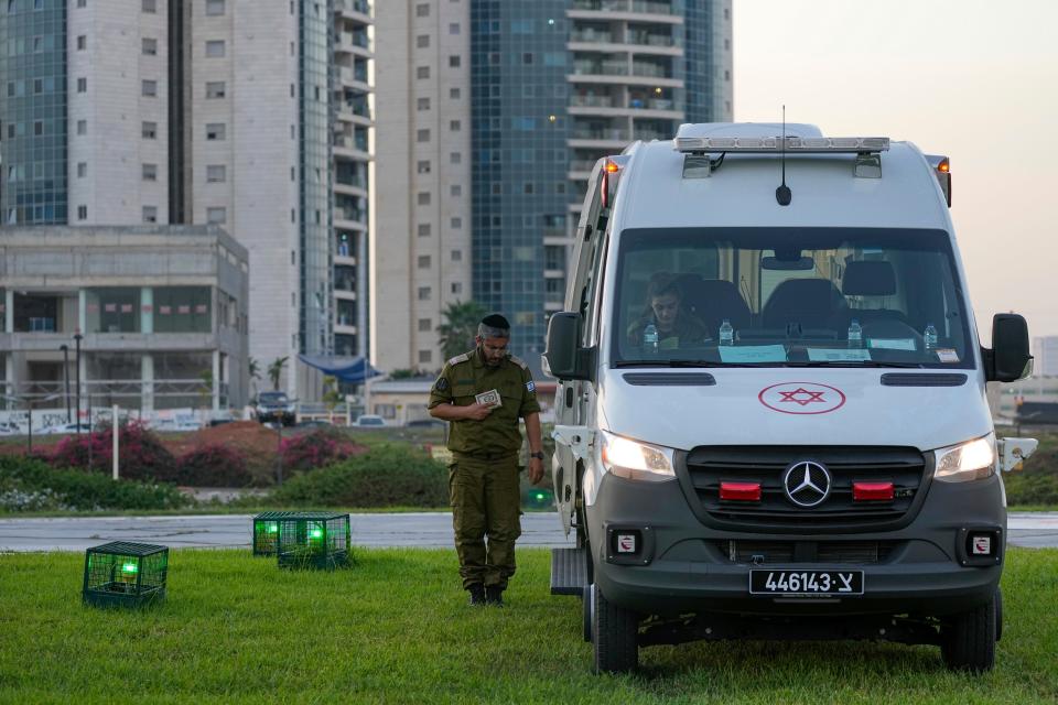 Israeli security forces stand next to ambulances outside the helipad of Schneider Children's Medical Center in Petah Tikva, Israel, in preparations for the release of Israeli hostages held by Hamas in the Gaza strip on Friday.