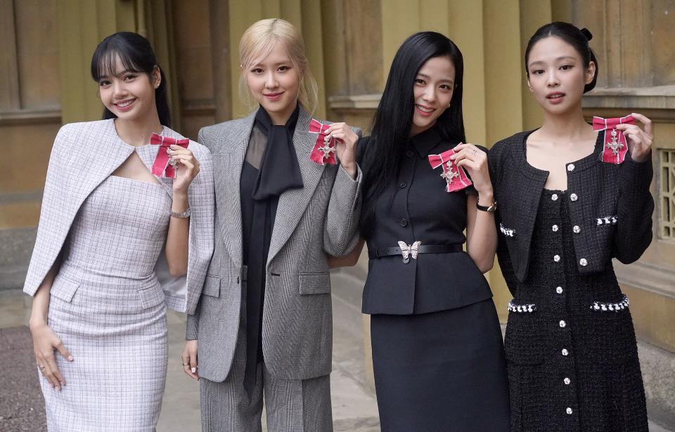 K-Pop band Blackpink's members, Lalisa Manoban, Roseanne Park, Jisoo Kim and Jennie Kim pose with their medals following a special investiture ceremony to present them with Honorary MBEs (Member of the Order of the British Empire), at Buckingham Palace in London on November 22, 2023, on the second day of the South Korean President's three-day state visit to the UK. (Photo by Victoria Jones / POOL / AFP) (Photo by VICTORIA JONES/POOL/AFP via Getty Images)