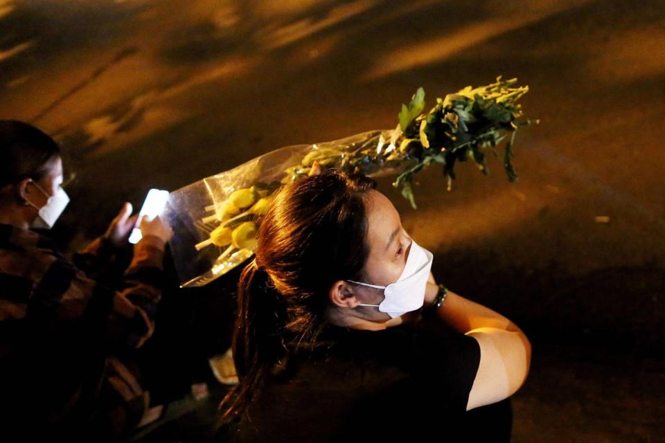 Family members of victims of the An Phu karaoke bar fire wait outside the Thuan An General hospital (AFP via Getty Images)