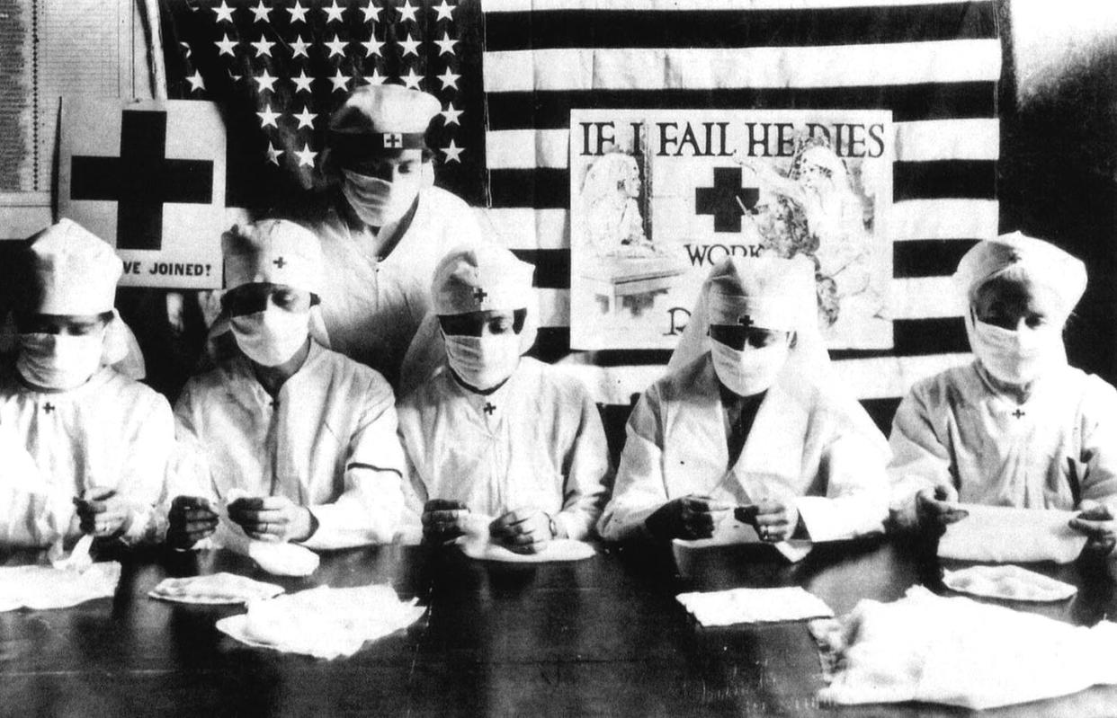 <span class="caption">U.S. Red Cross volunteers in 1918.</span> <span class="attribution"><a class="link " href="https://www.gettyimages.com/detail/news-photo/red-cross-volunteers-fighting-against-the-spanish-flu-news-photo/89857849?adppopup=true" rel="nofollow noopener" target="_blank" data-ylk="slk:Apic/Getty Images;elm:context_link;itc:0;sec:content-canvas">Apic/Getty Images</a></span>