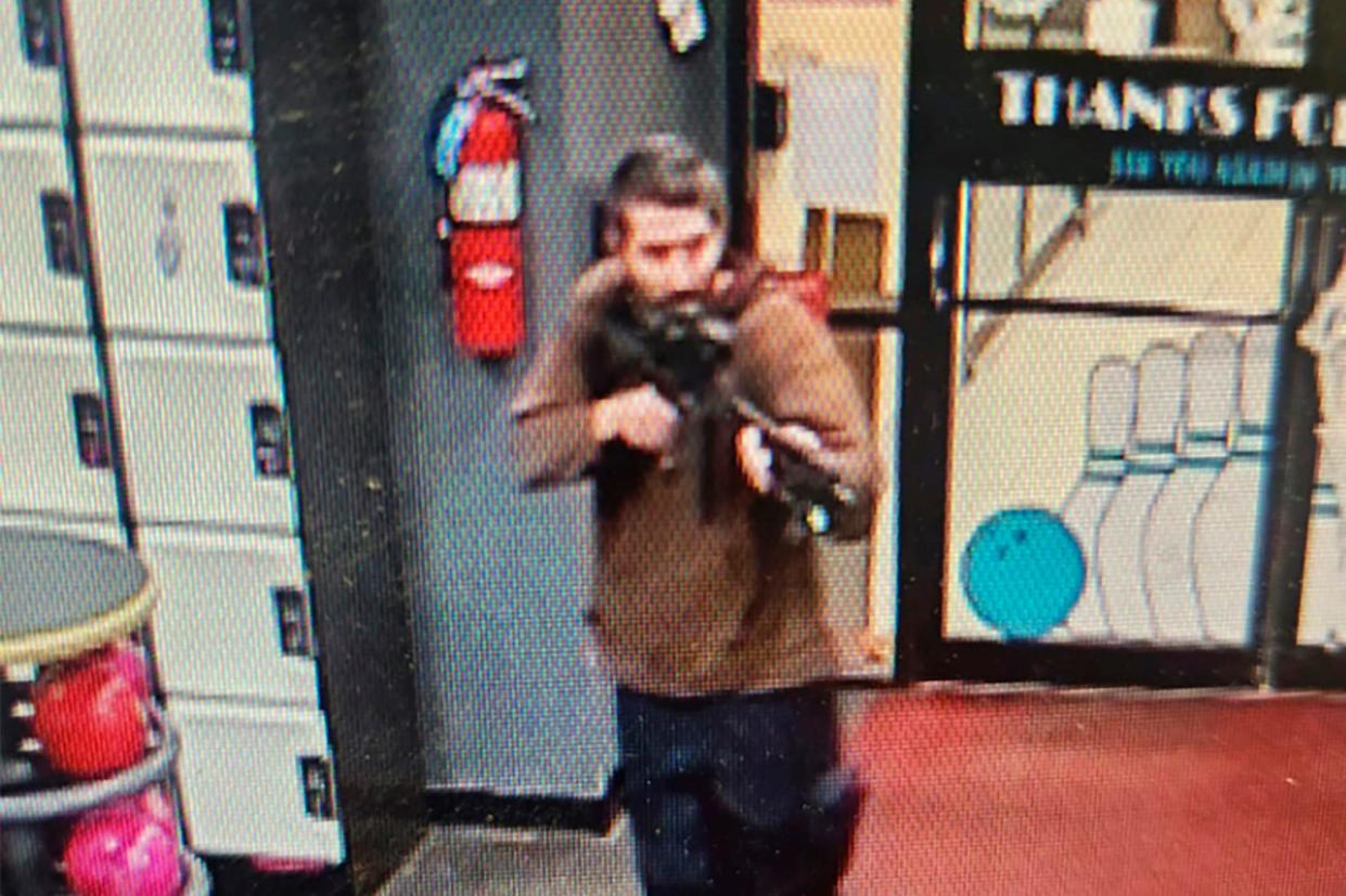 In this image from video released by the Androscoggin County Sheriff's Office, a gunman enters Just-In-Time Recreation in Lewiston, Maine, on Wednesday, Oct. 25, 2023. The suspect in the mass shootings that left 18 people dead remained at large Friday. (Credit: Androscoggin County Sheriff's Office via AP)
