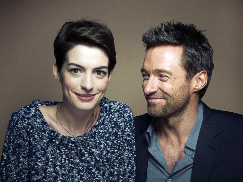 This Dec. 2, 2012 photo shows actors Anne Hathaway, left, and Hugh Jackman in New York. Hathaway portrays Fantine and Jackman portrays Jean Valjean in the film adaptation of the Victor Hugo novel, "Les Miserables." The film opens on Christmas Day. (Photo by Victoria Will/Invision/AP)