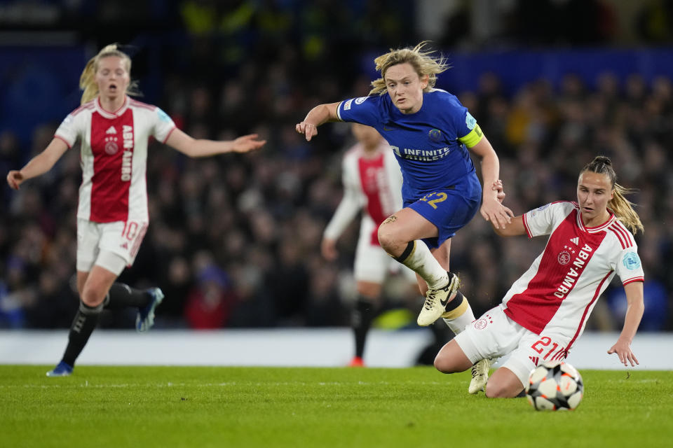 Chelsea's Erin Cuthbert, center, fights for a ball with Ajax's Rosa van Gool, right, during the Women's Champions League quarterfinal second leg soccer match between Chelsea and Ajax at Stamford Bridge Stadium in London, Wednesday, March 27, 2024. (AP Photo/Kirsty Wigglesworth)