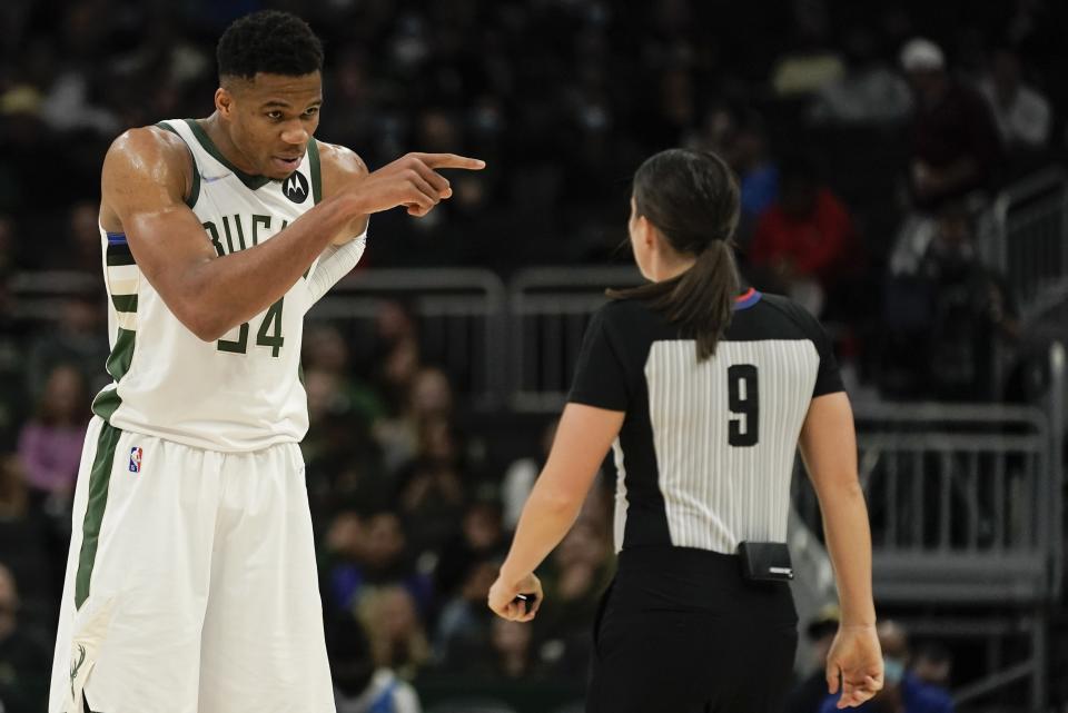 Milwaukee Bucks' Giannis Antetokounmpo argues a call with referee Natalie Sago (9) during the first half of an NBA preseason basketball game against the Dallas Mavericks Friday, Oct. 15, 2021, in Milwaukee. (AP Photo/Morry Gash)