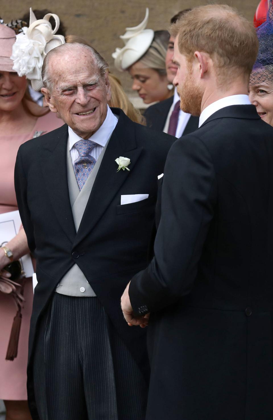 Britain's Prince Philip, Duke of Edinburgh reacts as he talks with Britain's Prince Harry, Duke of Sussex as they leave St George's Chapel in Windsor Castle, Windsor, west of London, on May 18, 2019, after the wedding of Lady Gabriella Windsor and Thomas Kingston. - Lady Gabriella, is the daughter of Prince and Princess Michael of Kent. Prince Michael, is the Queen Elizabeth II's cousin. (Photo by Steve Parsons / POOL / AFP)        (Photo credit should read STEVE PARSONS/AFP/Getty Images)