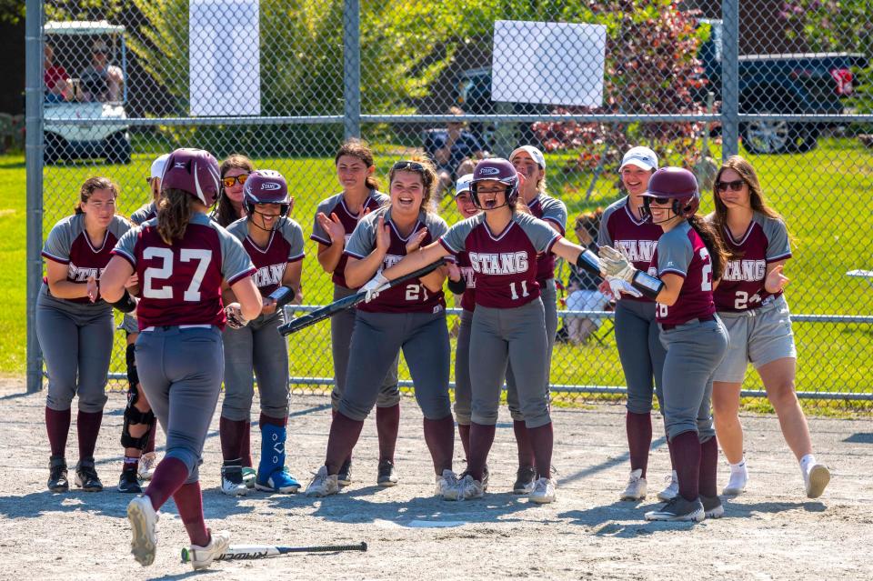 The Spartans come out to celebrate with Mikayla Brightman after her home run.