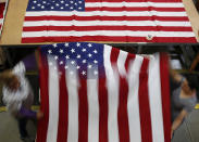 <p>Workers unfurl an American flag at the FlagSource facility in Batavia, Illinois, U.S., on Tuesday, June 27, 2017. (Photo: Jim Young/Bloomberg via Getty Images) </p>