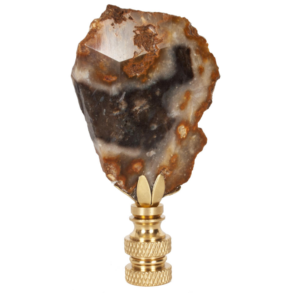 This undated photo provided by Hillary Thomas Designs shows a Norwegian Wood finial by Hillary Thomas that is a sliver of petrified wood. The neutral hues and striations add a distinctive touch to a lamp, and bring one of fall’s hot trends into play. (AP Photo/Hillary Thomas Designs)