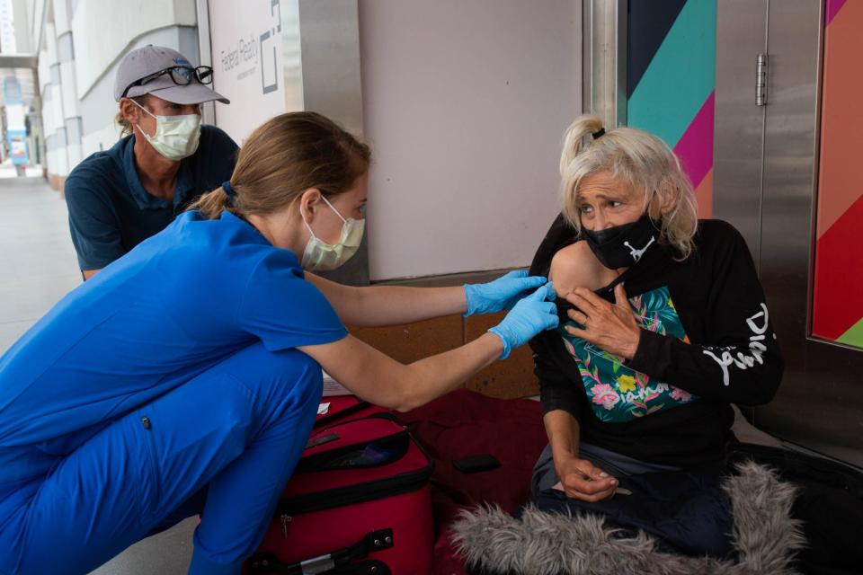 Dr. Coley King and a medical resident prepare to administer an injection to Suzanna Jordan, 65.