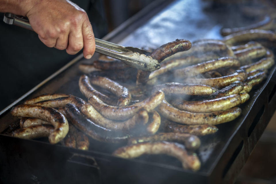 A man cooks sausages during an event marking the 125th anniversary of the Swiss Farmers' Union in the Swiss capital Bern, on Sept. 19, 2022.<span class="copyright">Fabrice Coffrini—AFP/Getty Images</span>