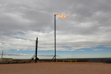 Natural gas flares off at a production facility owned by Exxon near Carlsbad, New Mexico, U.S. February 11, 2019. REUTERS/Nick Oxford