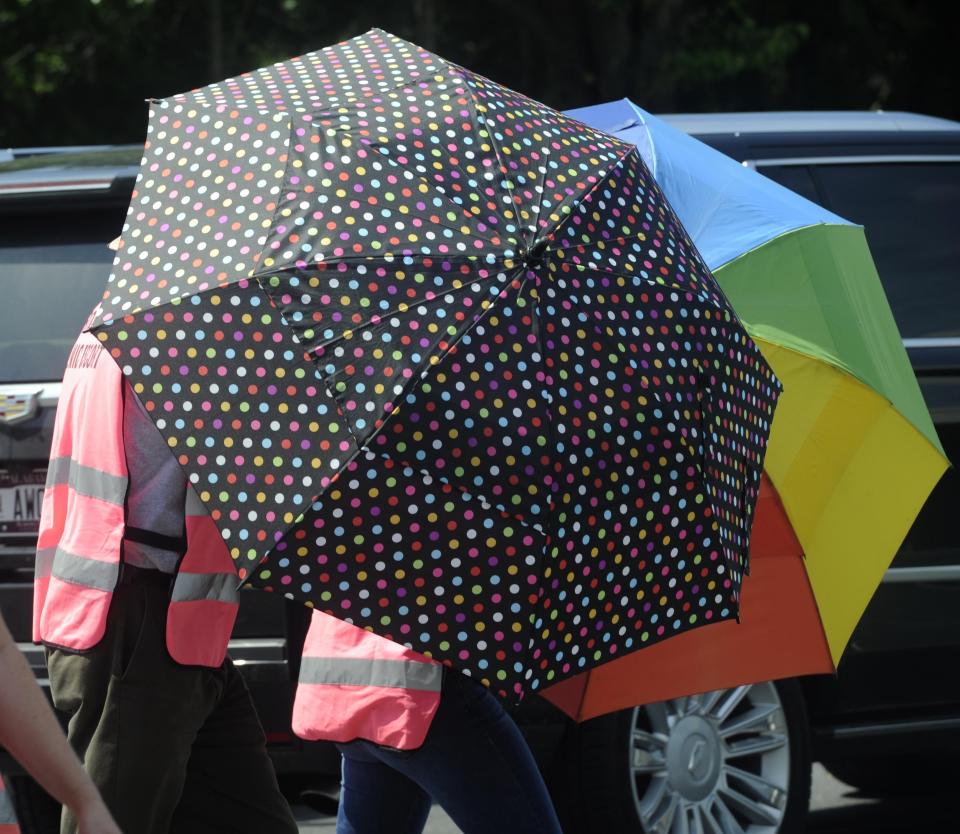 Escorts, using umbrellas, shield clients from the gestures and voices of anti-abortion activists standing on the sidewalk in front of the Alabama Women's Wellness Center Friday, May 17, 2019 in Huntsville, Ala. The Alabama legislation signed into law Wednesday would make performing or attempting to perform an abortion at any stage of pregnancy a felony. The ban does not allow exceptions for rape and incest.(AP Photo/Eric Schultz)