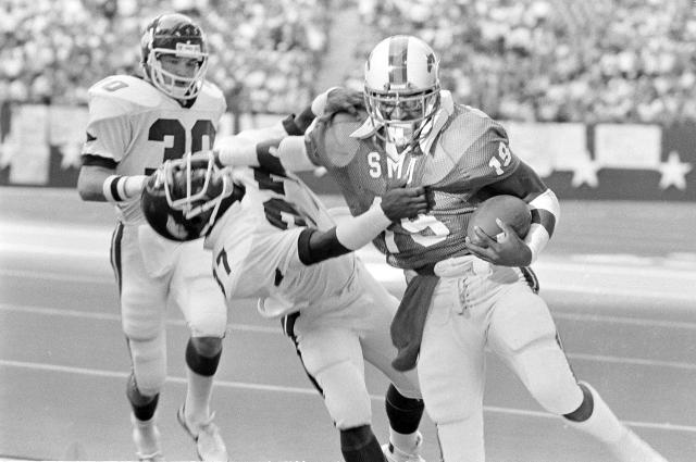 Eric Dickerson of the SMU Mustangs carries the ball during a game