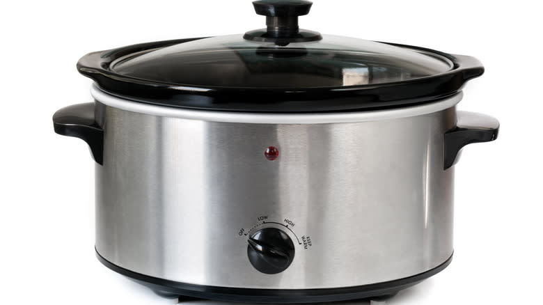 slow cooker on white background