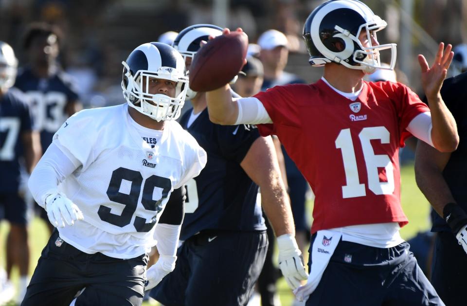 Rams Aaron Donald rushes quarterback Jared Goff.