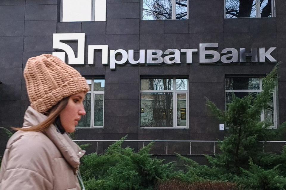 A woman passes by PrivatBank 's office in downtown Kyiv on Dec. 15, 2021. (Volodymyr Petrov)