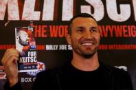 Britain Boxing - Tyson Fury & Wladimir Klitschko Head-to-Head Press Conference - Landmark London Hotel - 12/9/16 Wladimir Klitschko poses with an image of Tyson Fury during the press conference Action Images via Reuters / Peter Cziborra Livepic