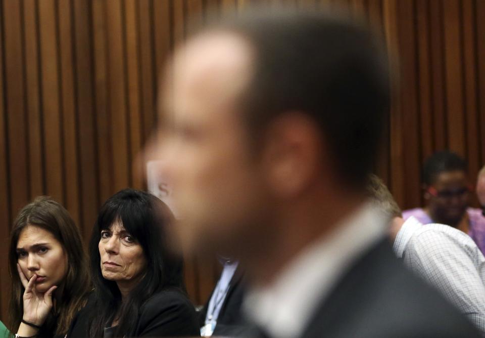 An unidentified family friend of the Steenkamp family glances at Olympic and Paralympic track star Oscar Pistorius during the fifth day of his trial for the murder of his girlfriend Reeva Steenkamp at the North Gauteng High Court in Pretoria, March 7, 2014. REUTERS/Themba Hadebe/Pool (SOUTH AFRICA - Tags: SPORT ATHLETICS CRIME LAW)