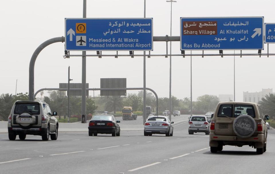 A road sign gives directions to the newly opened Hamad International Airport in Doha, Qatar, on Wednesday, April 30, 2014. A massive new airport in the Qatari capital has started handling its first commercial flights after years of delays as the natural-gas rich Gulf nation works to transform itself into a major aviation hub. (AP Photo/Osama Faisal)