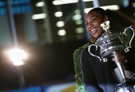 Tennis - Australian Open - Melbourne Park, Melbourne, Australia - early 29/1/17 Serena Williams of the U.S. poses with the Women's singles trophy after winning her final match. REUTERS/Edgar Su