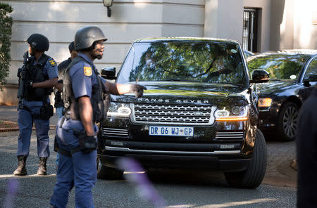 FILE PHOTO: A police convoy leaves the home of the Gupta family in Johannesburg, South Africa, February 14, 2018.REUTERS/James Oatway/File Photo