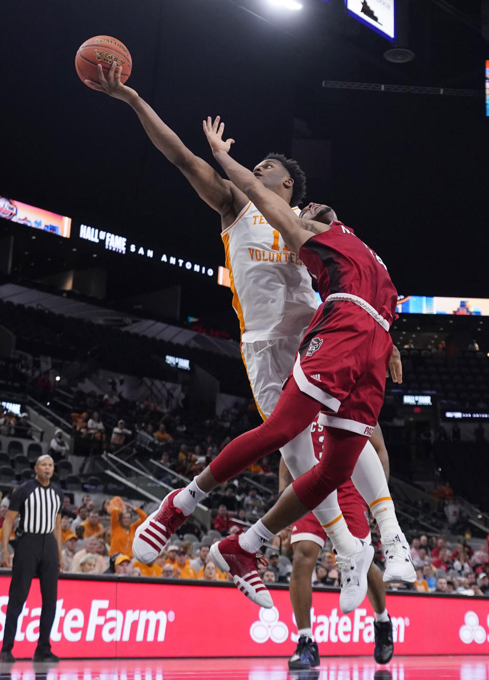 Tennessee forward Tobe Awaka (11) and North Carolina State guard Casey Morsell battle for a rebound during the second half of an NCAA college basketball game in San Antonio, Saturday, Dec. 16, 2023. (AP Photo/Eric Gay)