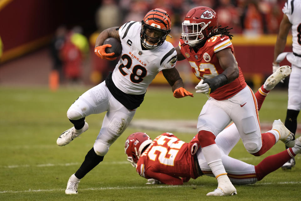 Cincinnati Bengals running back Joe Mixon (28) runs with the ball as Kansas City Chiefs linebacker Nick Bolton (32) defends during the first half of an NFL football game Sunday, Dec. 31, 2023, in Kansas City, Mo. (AP Photo/Charlie Riedel)