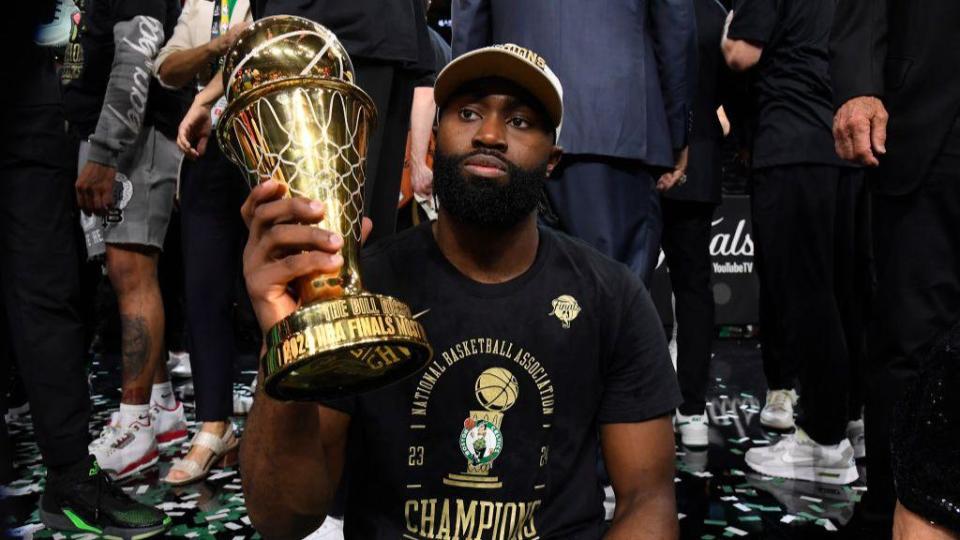 Jaylen Brown holds the MVP trophy after the NBA Finals 