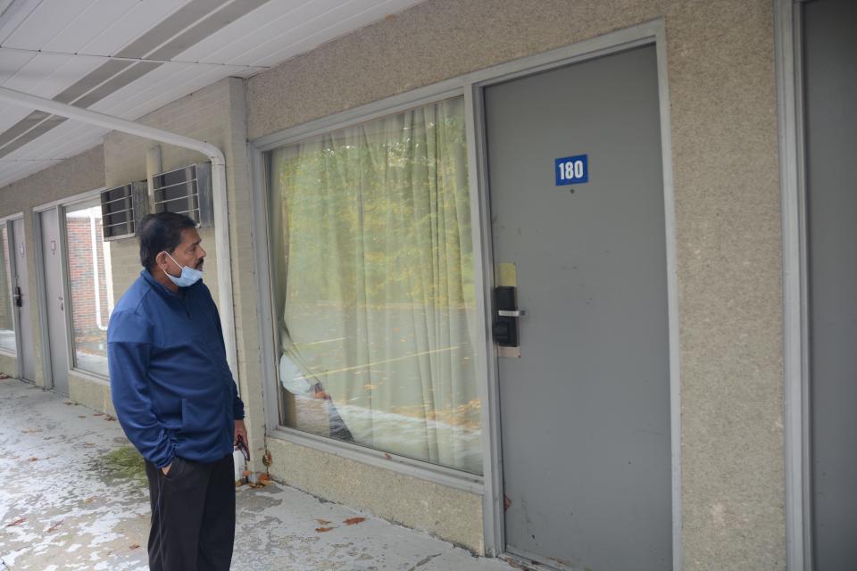 Kanu Patel, manager of the Casino Motel, checks on Room 180 where a woman was reportedly shot.