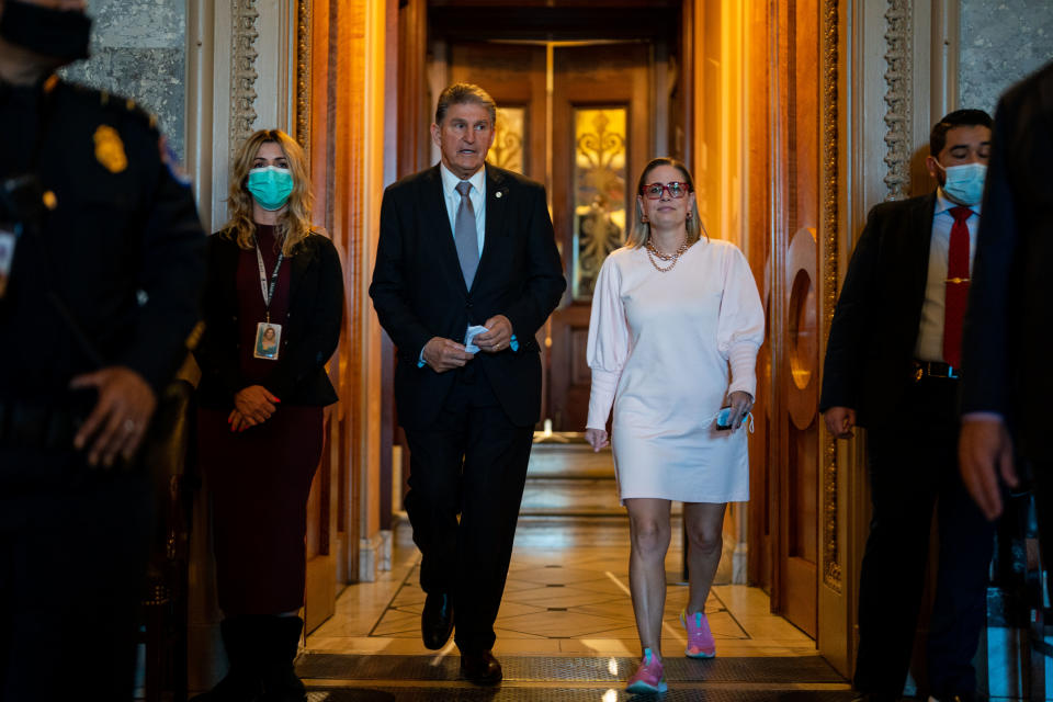 Sen. Joe Manchin, D-W.Va., leaves the Senate Chamber with Sen. Kyrsten Sinema, D-Ariz., after a vote in the Senate at the U.S. Capitol Building on Nov. 3.