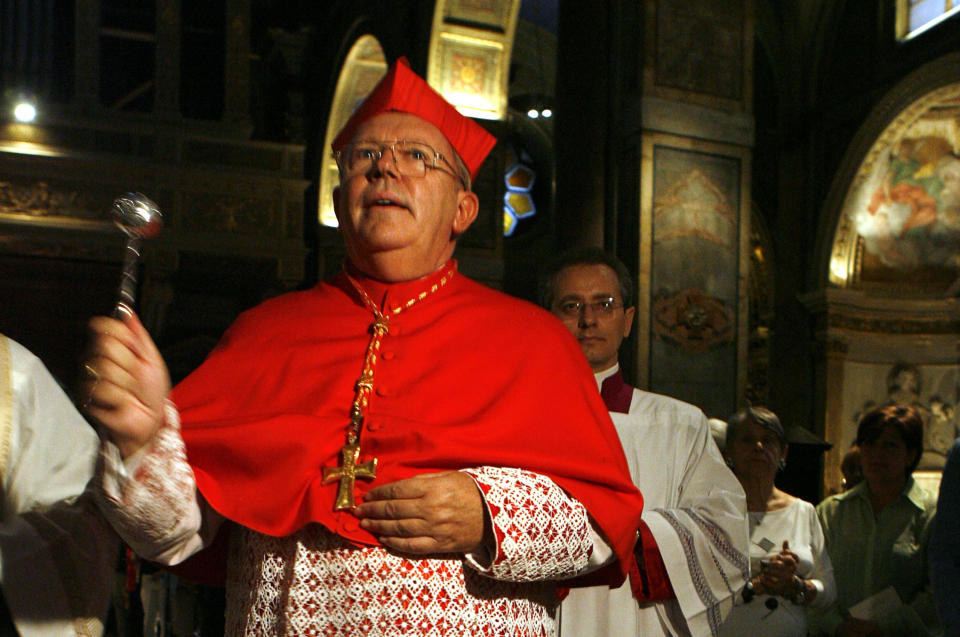 FILE - Archbishop of Bordeaux, France, Cardinal Jean-Pierre Bernard Ricard blesses his titular church - Sant' Agostino - during a ceremony to officially take possession of his church, in Rome, Sunday, Oct. 8, 2006. Cardinal Jean-Pierre Ricard said on Monday Nov.7, 2022 that he had abused a 14-year-old girl thirty-five years ago and is withdrawing from his functions. The move comes after a report issued last year revealed a large number of child sex abuse cases within the country's Catholic Church. (AP Photo/Andrew Medichini, File)