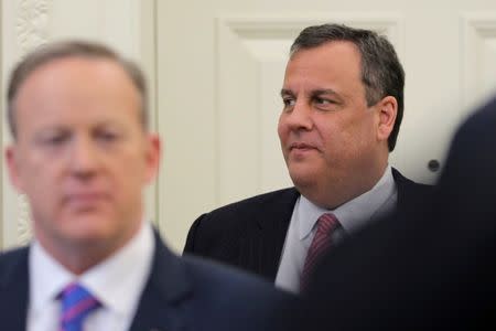 Governor of New Jersey Chris Christie stands next to White House Press Secretary Sean Spicer (L) at the Oval Office of the White House in Washington, U.S., February 14, 2017. REUTERS/Carlos Barria