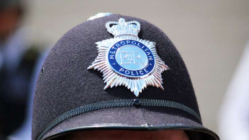 Close-up of the insignia on a bobby's hat in England.