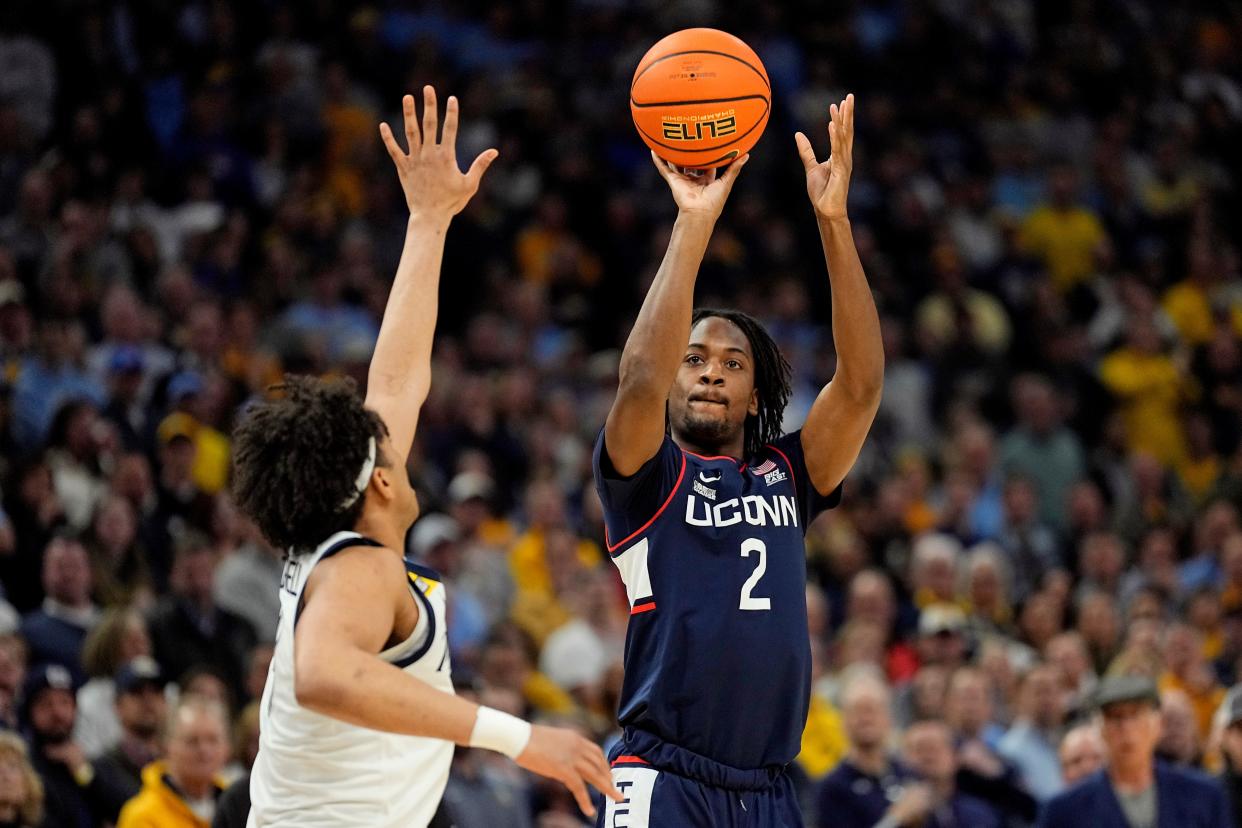 Mar 6, 2024; Milwaukee, Wisconsin, USA; Connecticut Huskies guard Tristen Newton (2) shoots over Marquette Golden Eagles guard Stevie Mitchell (4) during the first half at Fiserv Forum. Mandatory Credit: Jeff Hanisch-USA TODAY Sports