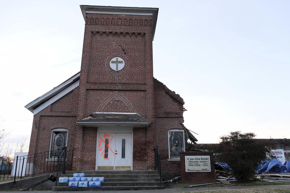 Spray paint marks the front door of the St. James African Methodist Episcopal Church in Mayfield, Ky., on Jan 9, 2022. “We don’t have a building, but other churches within our denomination have been sending us supplies,” said Thomas Bright, steward at St. James AME, which suffered major damage to its roof and sanctuary. (AP Photo/Audrey Jackson)