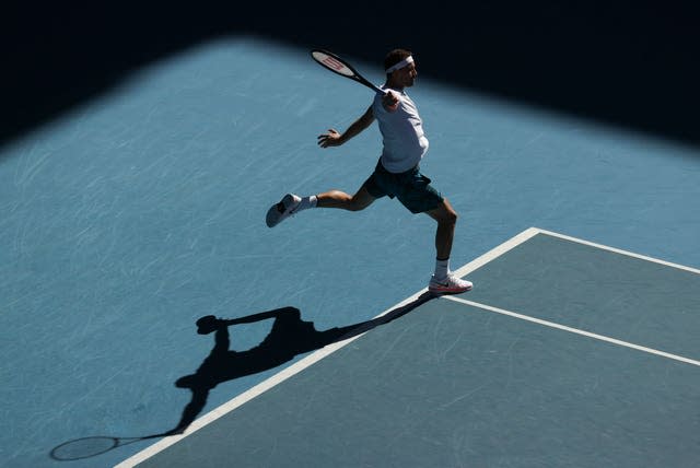 The sun shines on Grigor Dimitrov as he hits a one-handed backhand