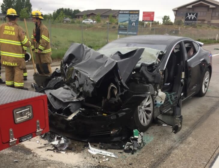 FILE - In this May 11, 2018, file photo, released by the South Jordan Police Department shows a traffic collision involving a Tesla Model S sedan with a fire department mechanic truck stopped at a red light in South Jordan, Utah. Heather Lommatzsch, the Utah driver who slammed her Tesla into the stopped firetruck at a red light while using the vehicle's semi-autonomous function, is suing the company. (South Jordan Police Department via AP, File)
