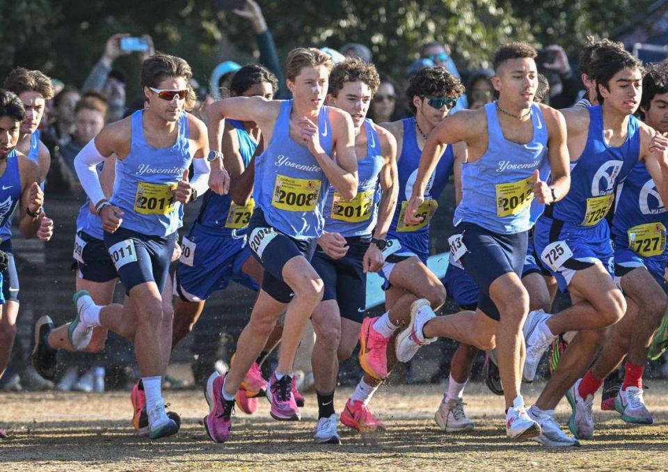 Members of the Yosemite High cross country team, from left, Jack Olney, Noah Graffigna, Anthony Ruiz and Ford Stegge start off on the course during the boys Division V state cross country championships at Woodward Park in Fresno on Saturday, Nov. 25, 2023.